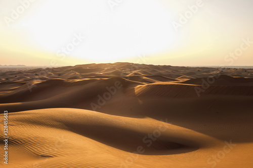 Desert landscape in the RUB al-Khali desert . The texture of sand dunes in the desert is yellow and orange. Red and yellow sand dunes
