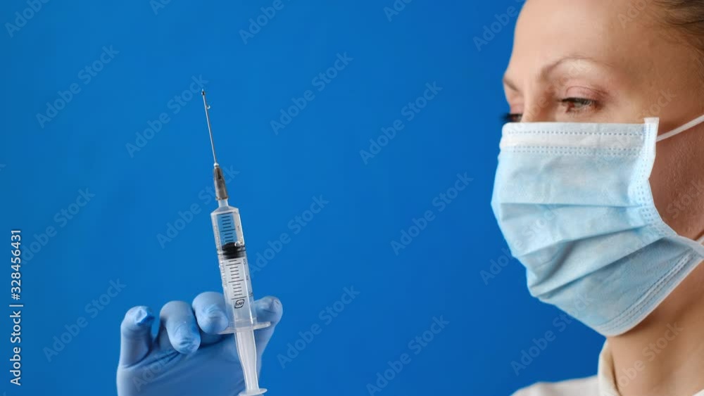 nurse about to give an injection. Female hands in sterile gloves with ...