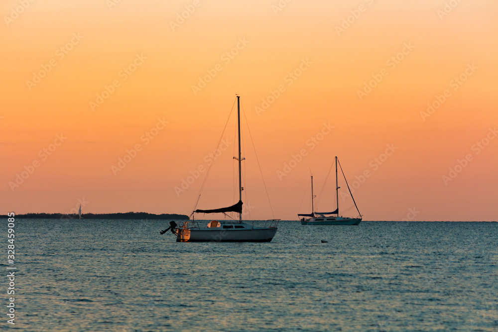 Golden hour sunset boats coursing