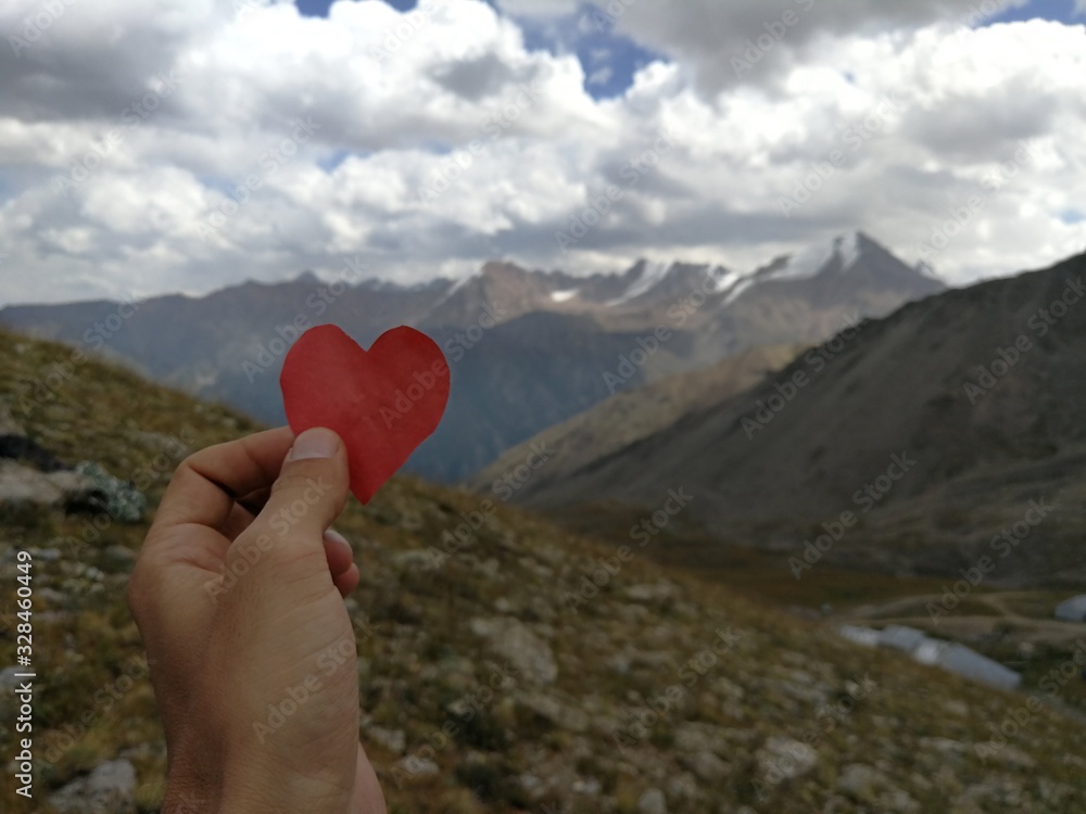 Fototapeta premium heart in hand on the background of blue sky