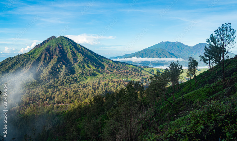 volcano Ruang next to Ijen covered in sulphur coming out uf Ijen. a mystic view early in the morning in Java, Indonesia volcano Ruang next to Ijen covered in sulphur coming out uf Ijen. a mystic view early in the morning in Java, Indonesia