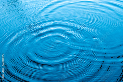 Blue water surface.Top view Closeup blue water rings, Circle reflections in pool.
