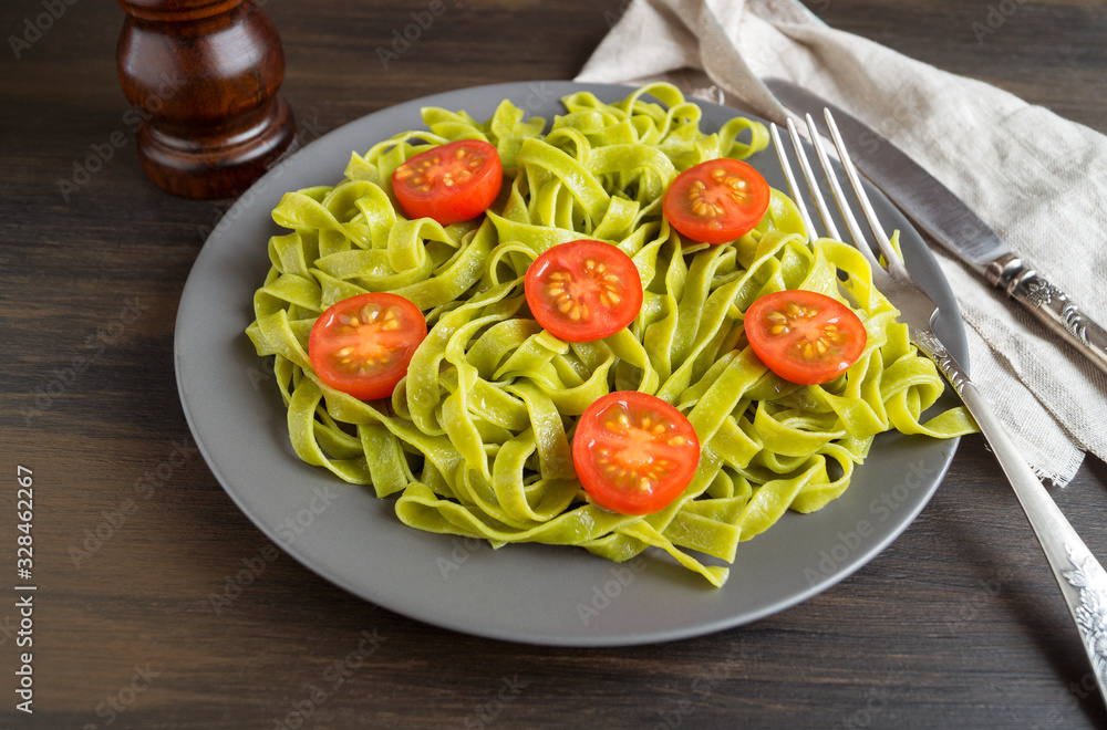 spinach tagliatelle with cherry tomatoes. proper diet.
