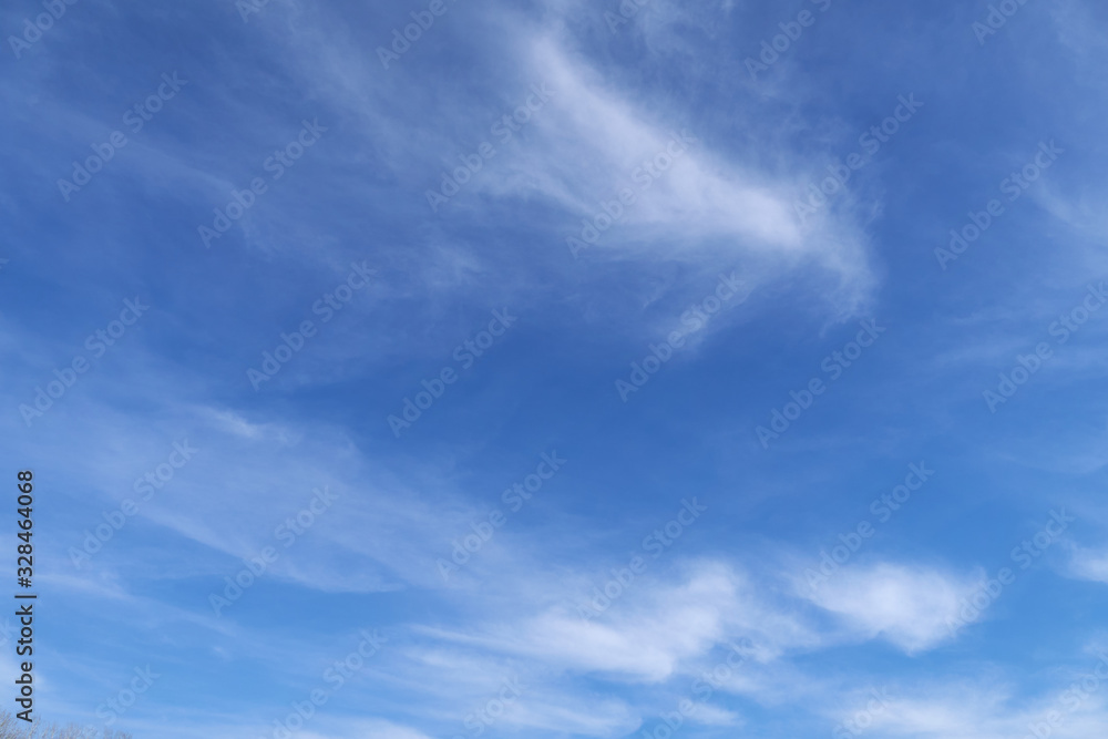 Bright beautiful blue sky with soft clouds for background or texture Bright beautiful blue sky with soft clouds for background or texture