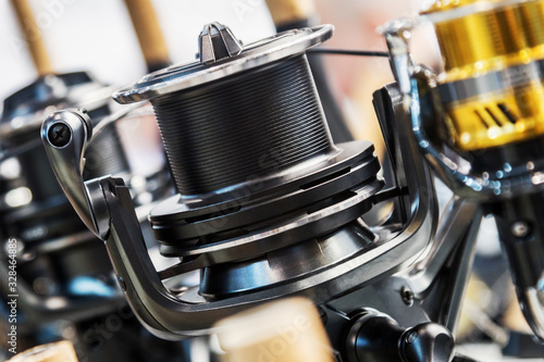fishing reels of different sizes on the counter in the fishing store. Shallow depth of field