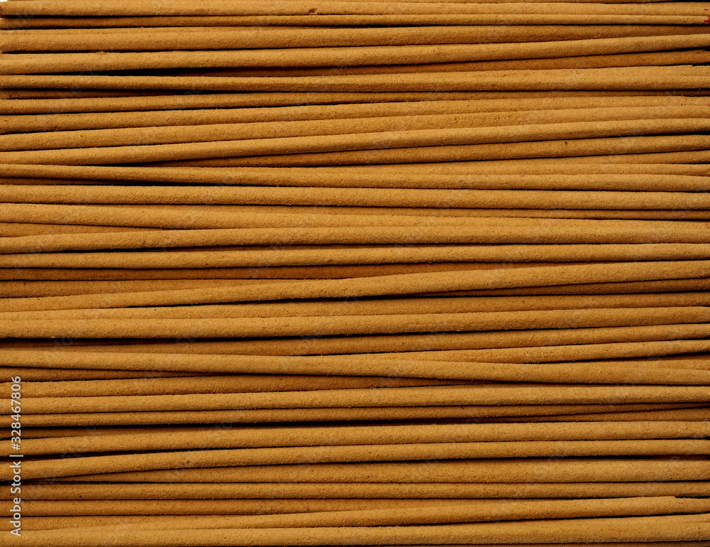 Close up of incense sticks showing brown powder in horizontal direction. Close up of incense sticks showing brown powder in horizontal direction.