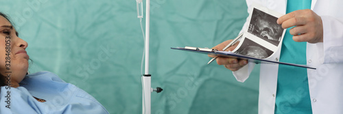 Woman was brought to hospital with pain in abdominal area. Doctor tells her bad news about problem. Miscarriage in early pregnancy concept