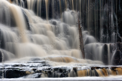 Water pouring over rocks at Byklev waterfall  Sweden.