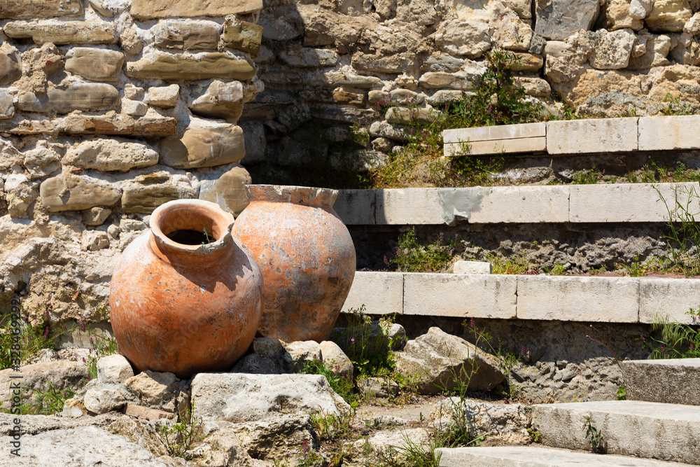 Fototapeta premium Ancient amphora in old town of Nesebar, Bulgaria. Ancient pottery pots. Two amphora 