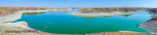 Blue lake in steppe canyon with blue sky. Natural landscape. Beautiful landscape. Beauty nature background. Beautiful sky. Kurty or Kurtinskoye lake.