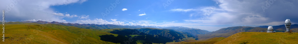 Panoramic landscape of observatory telescope on green valley among mountains mountains in day, great design for any purposes. Beautiful alpine landscape of Assy plateau in Kazakhstan. Assy observatory