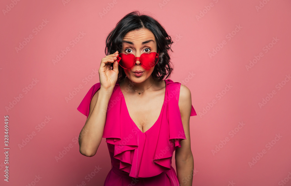 Females holidays. Beautiful trendy happy glamorous young woman in fashion wears and cool glasses in pink vivid style.