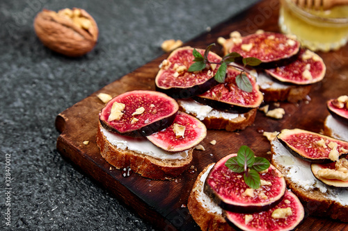 Bruschetta  or ctostini with cottage cheese, figs and honey. Sandwich with figs and goat cheese..