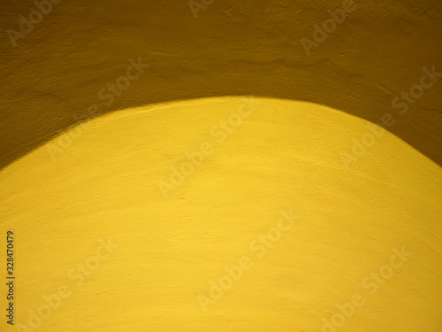 Yellow cement wall background.