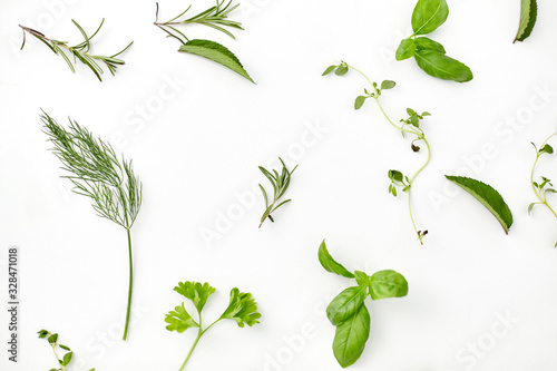 culinary  seasoning and organic concept - different greens  spices or herbs on white background