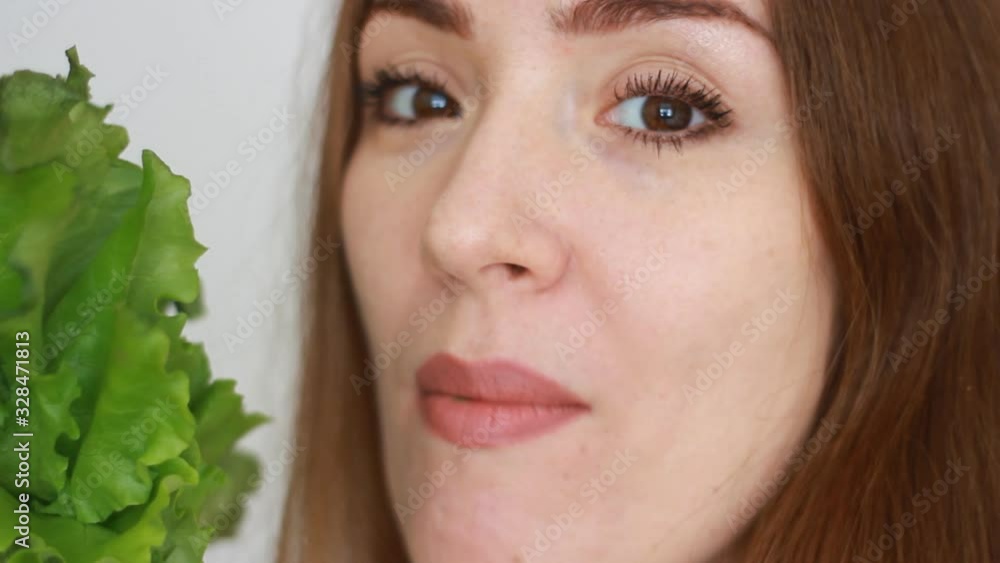 Young woman eating green salad. Concept weight control, diet, healthy raw food, vitamins, vegetarian Young woman eating green salad. Concept weight control, diet, healthy raw food, vitamins, vegetarian