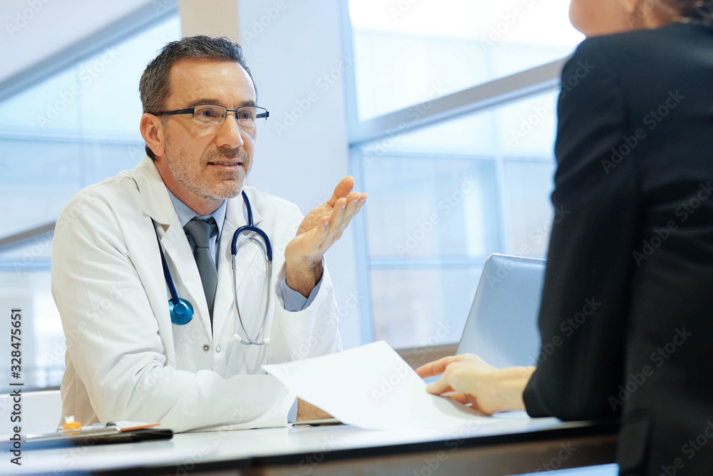 Specialist with patient in doctor's office Specialist with patient in doctor's office