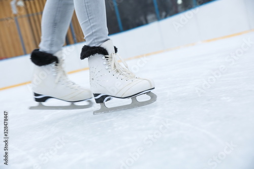 woman is ice skating on rink close up