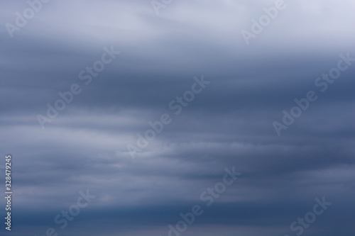 Clouds background. Scattered clouds on the sky. Blue and gray clouds.