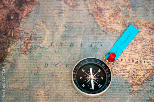 Compass put on Australia country over blur blue paper with text '' next travel'' on blurred vintage map. Travel and tourism concept or used for voyage trip travel advisor agency concept.