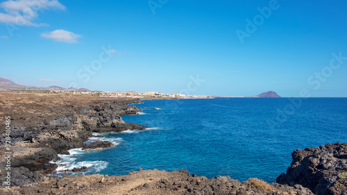 Rough and rocky landscape of the coastal walking path from Montana Amarilla to Amarilla Golf and Golf Del Sur with views of the small fishing villages and Montana Roja, Tenerife, Canary Islands, Spain