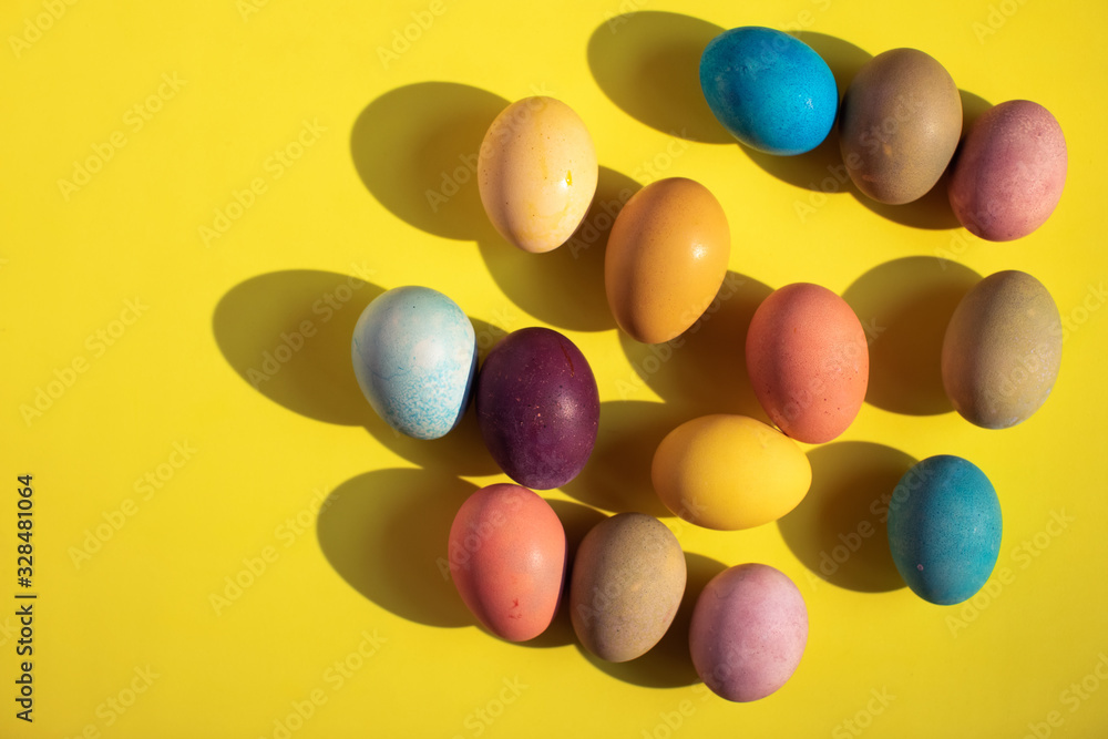 Happy Easter. Colorful Easter eggs on yellow background