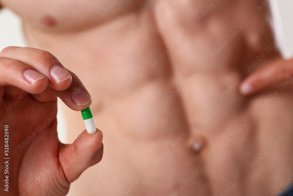 Athlete bodybuilder takes dope in the form of tablets form of pharma rapid progress in muscle development Athlete bodybuilder takes dope in the form of tablets form of pharma rapid progress in muscle development