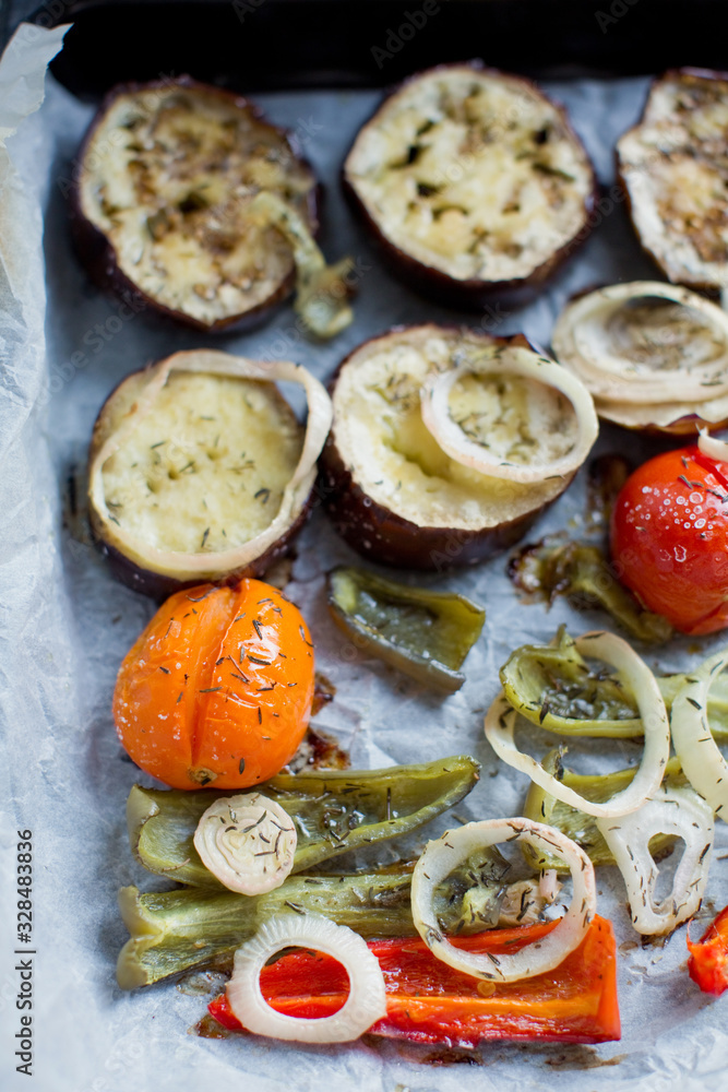 Tray with baked eggplant, tomatoes, onion and pepper