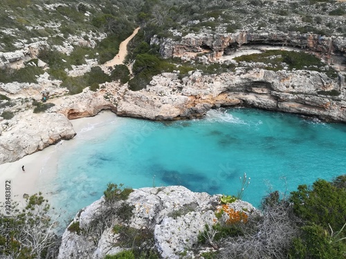 A man alone in a paradise beach in Mallorca Island. Cala Marmols.