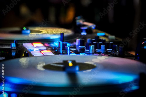 DJ vinyl players in dark nightclub, party in the dance club, DJ equipment, defocused 