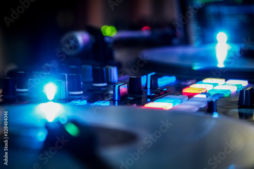 DJ vinyl players in dark nightclub  party in the dance club  DJ equipment  defocused 