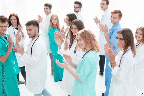 top view. a group of smiling doctors pointing at you.