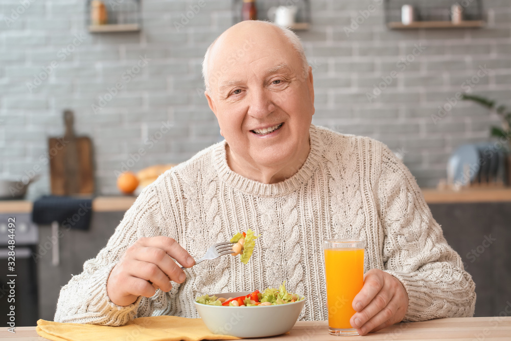 Portrait of elderly man having lunch at home Portrait of elderly man having lunch at home