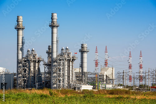 Power plant station building and industrial pipe system on blue sky background