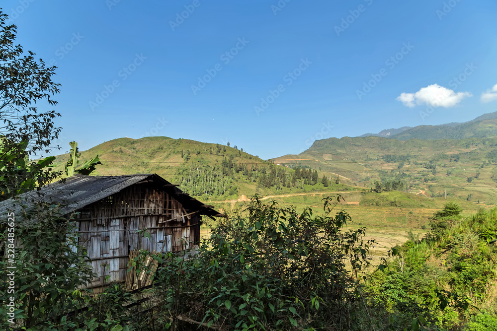 houses mountain landscape farmland green grass and blue sky