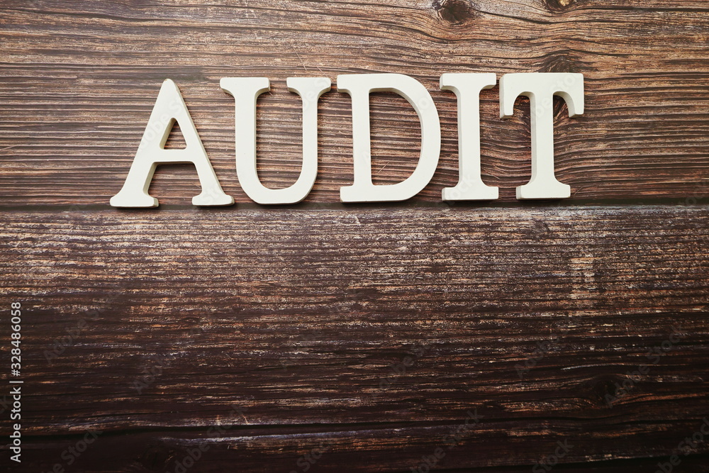Audit alphabet letters on wooden background Audit alphabet letters on wooden background