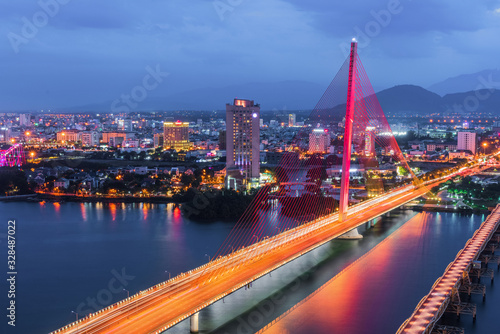 Han River Bridge (Cau Song Han) over the Han River in Da Nang, central Vietnam. Da Nang skyline cityscape by twilight period