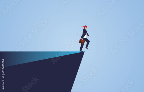 Blindness and crisis, blindfolded businessman walks to the cliff
