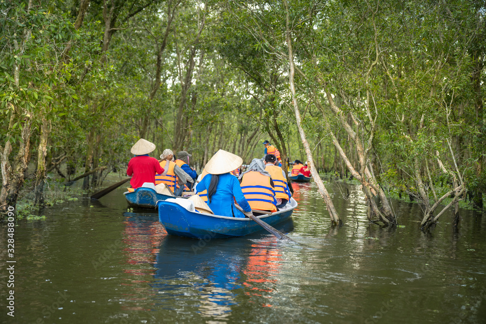 Tourism rowing boat in cajuput forest in floating water season in Mekong delta, Vietnam Tourism rowing boat in cajuput forest in floating water season in Mekong delta, Vietnam