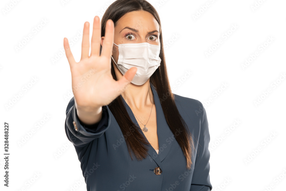 Shocked woman with stop hand and protective mask on her face Shocked woman with stop hand and protective mask on her face