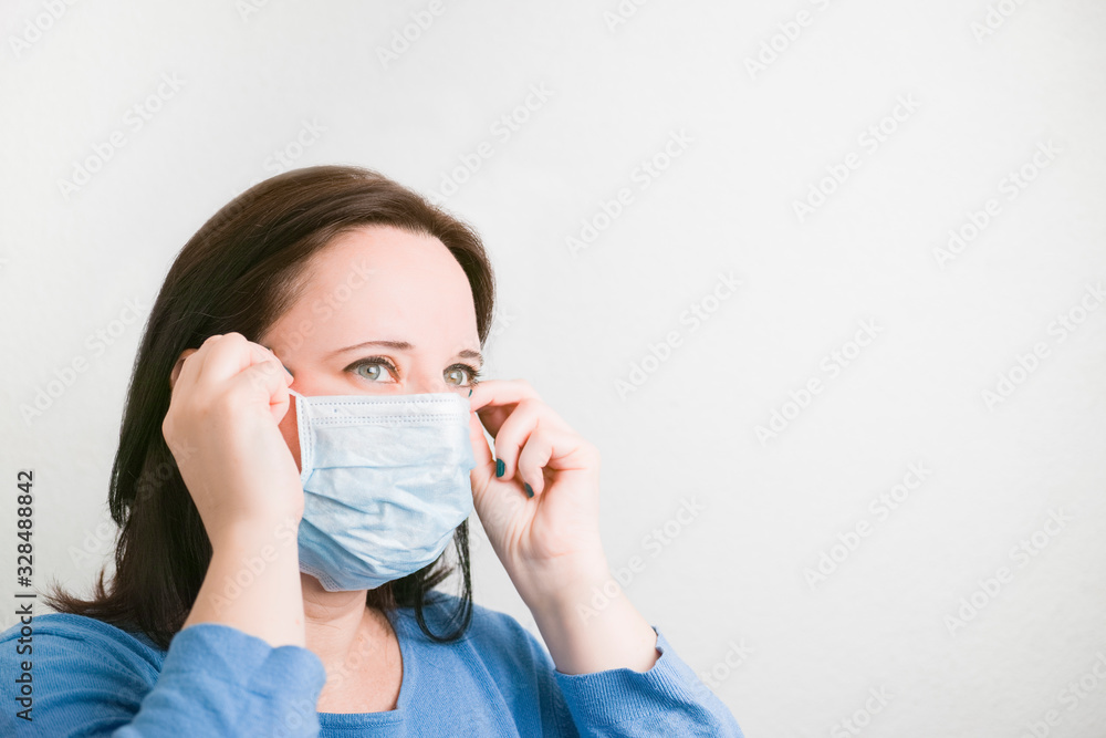Profile portrait of a woman who is wearing a protective mask against viruses on a white background. Profile portrait of a woman who is wearing a protective mask against viruses on a white background.