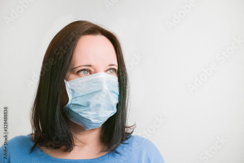 Portrait of a woman wearing a protective mask against viruses on a white background