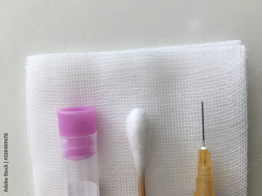Naklejka premium blood collection tube and syringe and swab with gauze in healthcare check uo concept