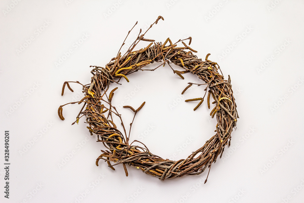 Fototapeta premium Wicker wreath of birch branches isolated on white background. Easter zero waste, DIY concept. Design element and decor
