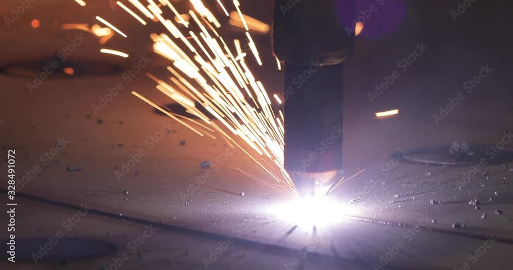 Plasma cutting of metal with a cnc. A plasma cutter cuts a workpiece from a sheet of metal. Laser cutter in production. Industrial metal cutting by plasma laser. 4K video. High definition video