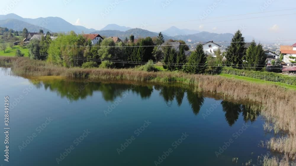 Powerlines in a Lake used for liquid chemical disposal with residential homes nearby, Aerial dolly in approach Powerlines in a Lake used for liquid chemical disposal with residential homes nearby, Aerial dolly in approach