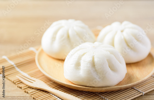 Steamed buns on wooden plate and fork ready to eating, Asian food
