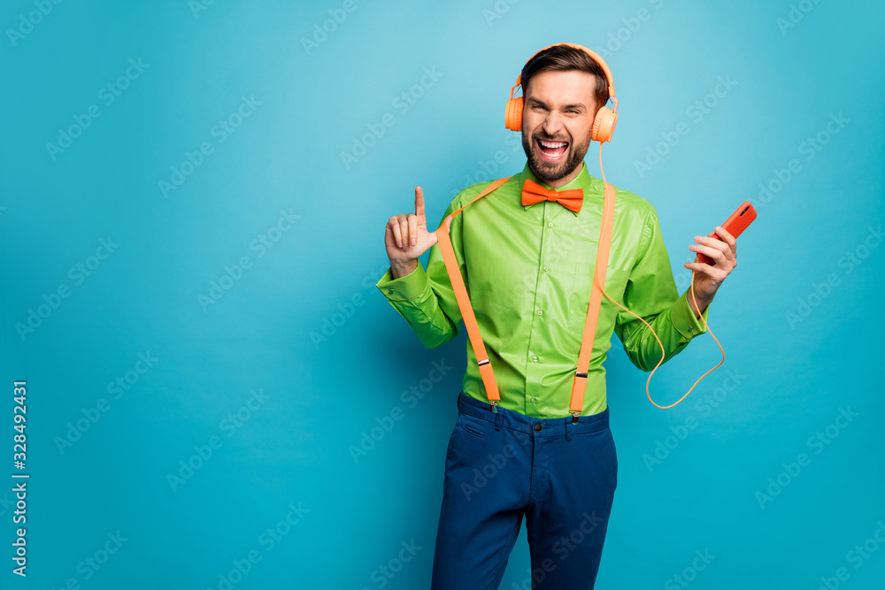 Portrait of his he nice attractive glad excited cheerful cheery guy listening hit pop music having fun free time isolated on bright vivid shine vibrant blue green teal turquoise color background Portrait of his he nice attractive glad excited cheerful cheery guy listening hit pop music having fun free time isolated on bright vivid shine vibrant blue green teal turquoise color background