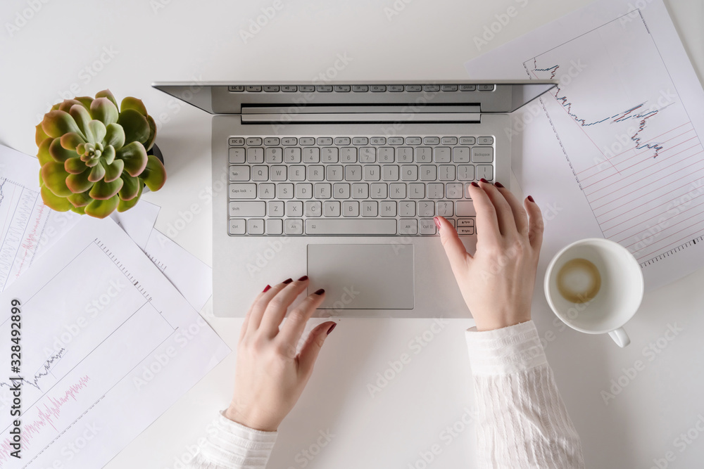 Φωτογραφία Woman freelancer finishing working and closes laptop with empty drink up cup of coffee and the end of working day
