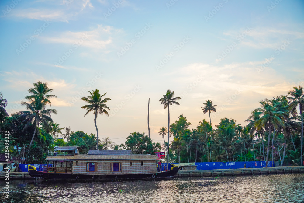River side view with coconut tree and house in alleppey. Kerala 